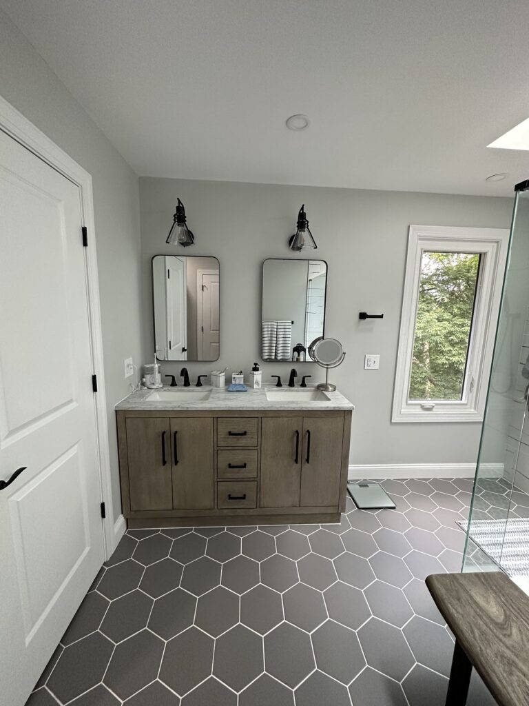 bathroom remodel with grey tiles and natural light being shown