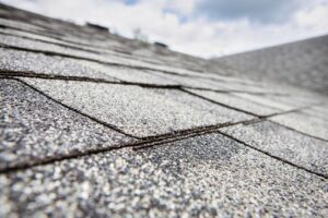 A close-up of granule weathering on asphalt shingles. 