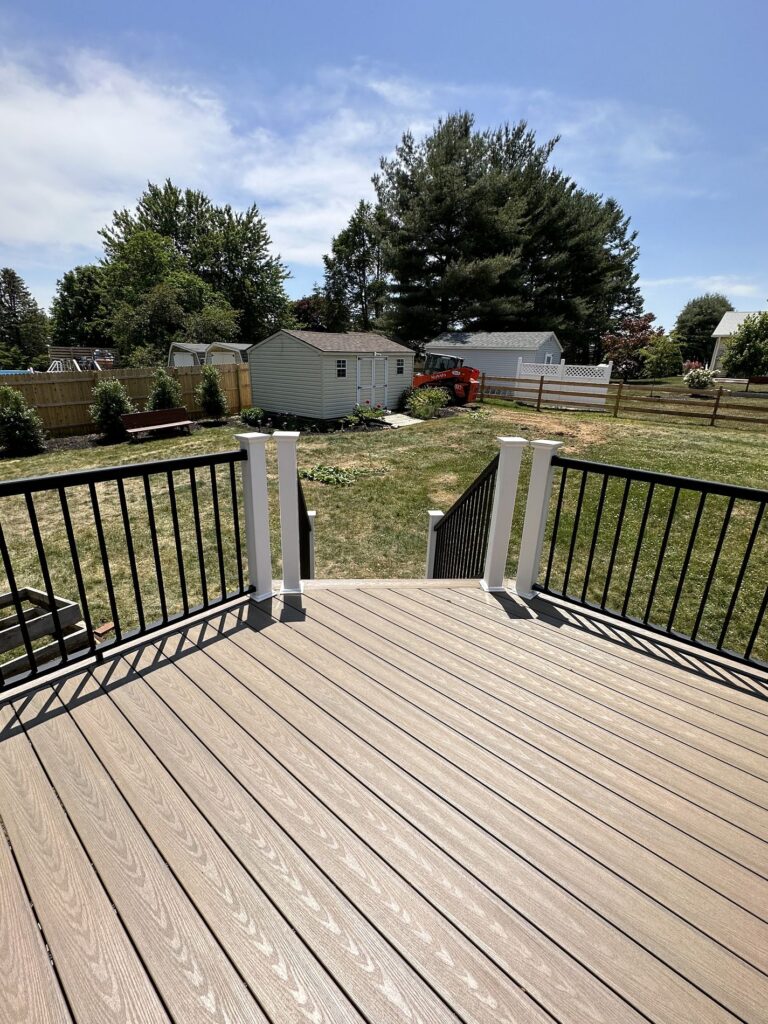 light wash wooden deck with black railings