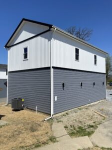 smaller exterior siding job of white and blue vinyl siding