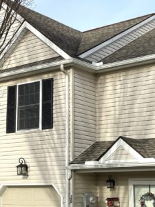 cream vinyl siding being shown on a residential house