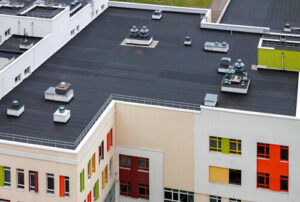 black commercial flat roofing on colorful building