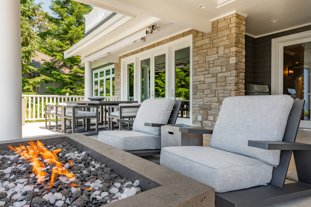 A shaded patio with a fire pit