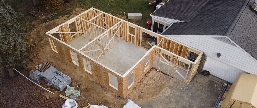 Wall framing of an affordable home addition in progress off the back of someone's house