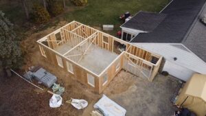 Wall framing of an affordable home addition in progress off the back of someone's house