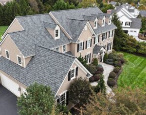 New roof from a residential roofing contractor on a tan home in a neighborhood
