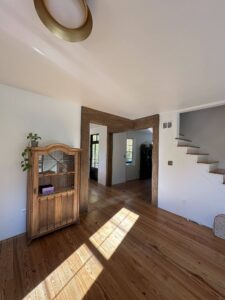 Interior remodel with wooden floors and trim around the doorway