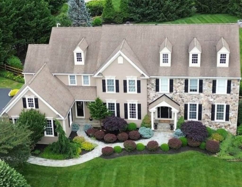 A house before their residential roof replacement in Chester Springs with faded tan shingles