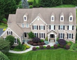 A house before their residential roof replacement in Chester Springs with faded tan shingles