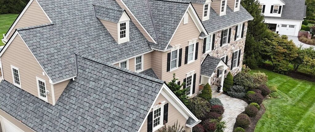 A house after their residential roof replacement in Chester Springs with gray shingles, taken at a side angle