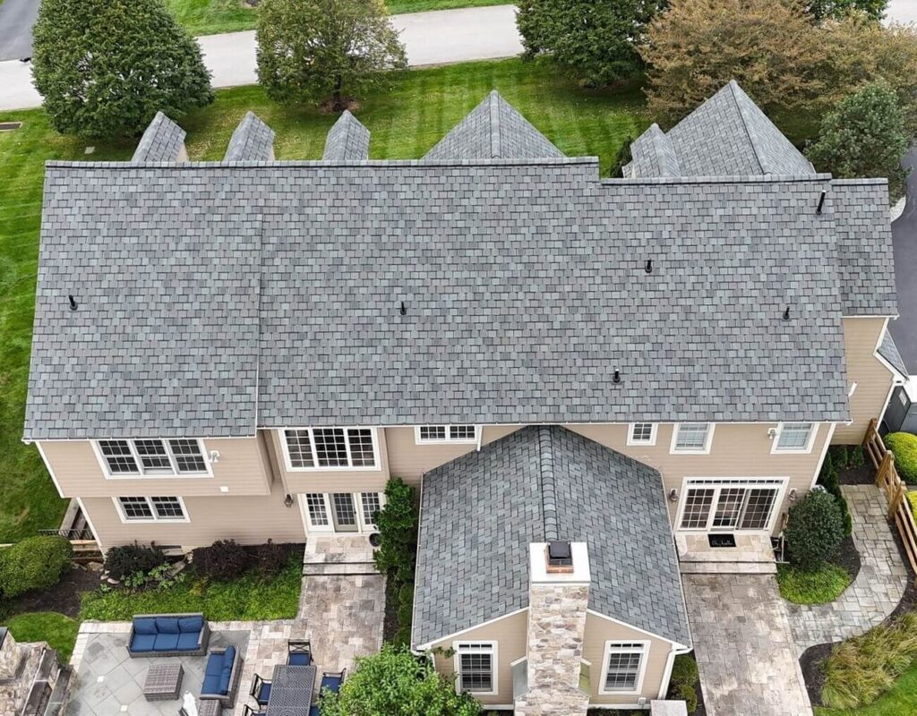 A house after their residential roof replacement in Chester Springs with gray shingles, taken from the back of the house