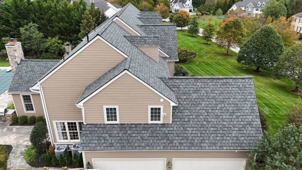 A house after their residential roof replacement in Chester Springs with gray shingles, taken from the side of the house