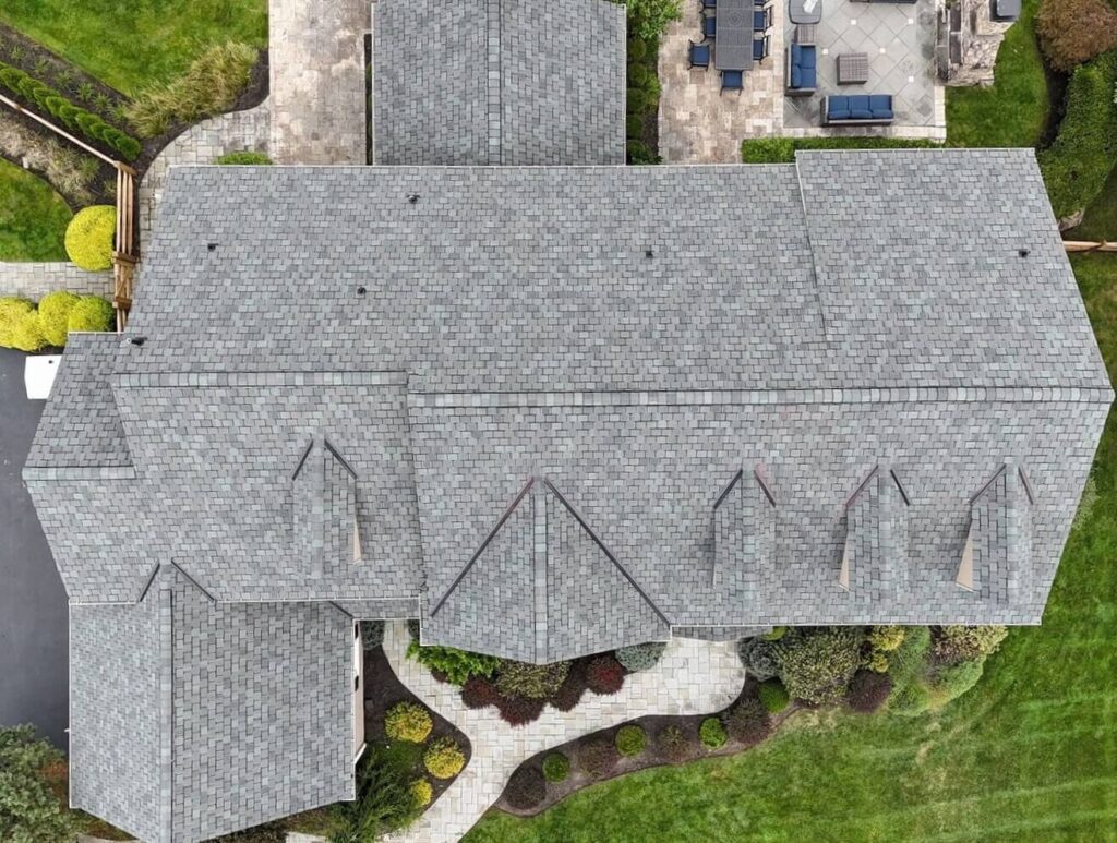 A house after their residential roof replacement in Chester Springs with gray shingles, taken from above the house.