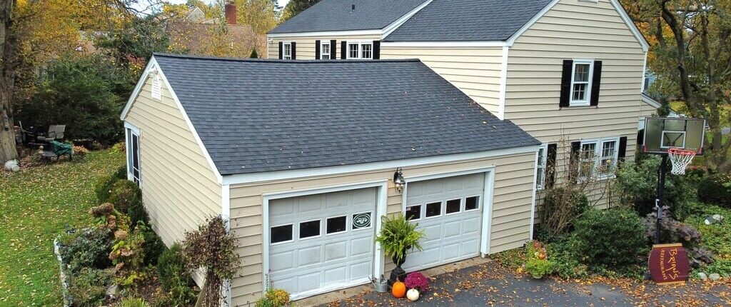 A house in the fall with pale yellow siding